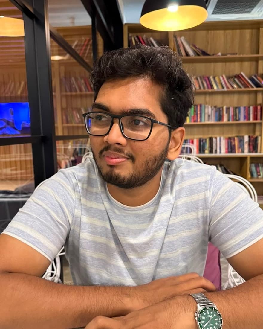 Sathwik Prathi, photographed at a desk in a library cafe